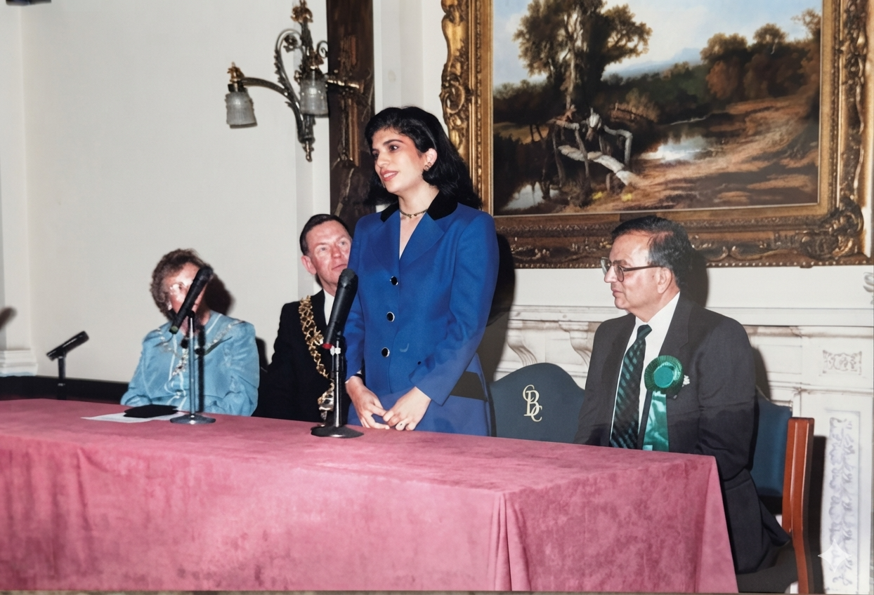 A speaker addressing guests from a civic top table, with a mayoral chain of office visible behind.